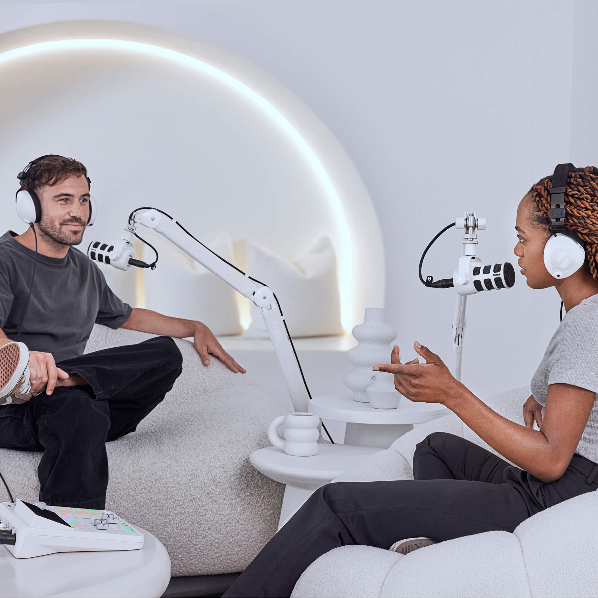 White RØDE PSA1+ and white PodMic in a bright podcast studio