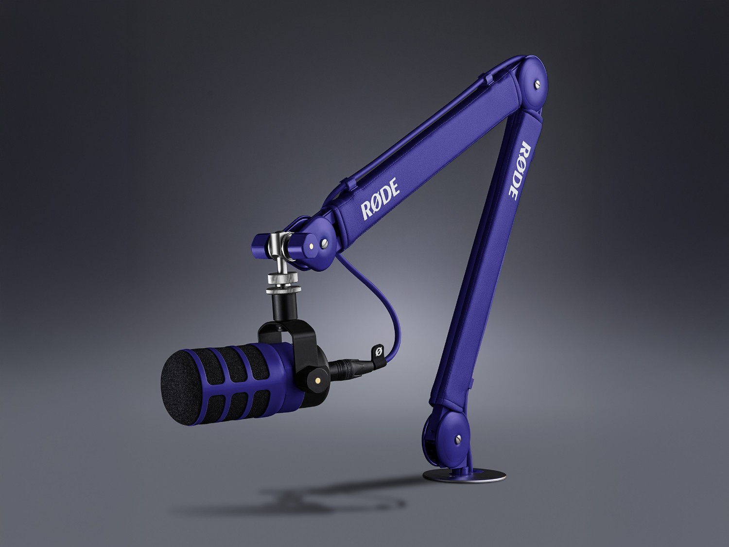 Purple RØDE PSA1+ arm with a microphone in a modern studio