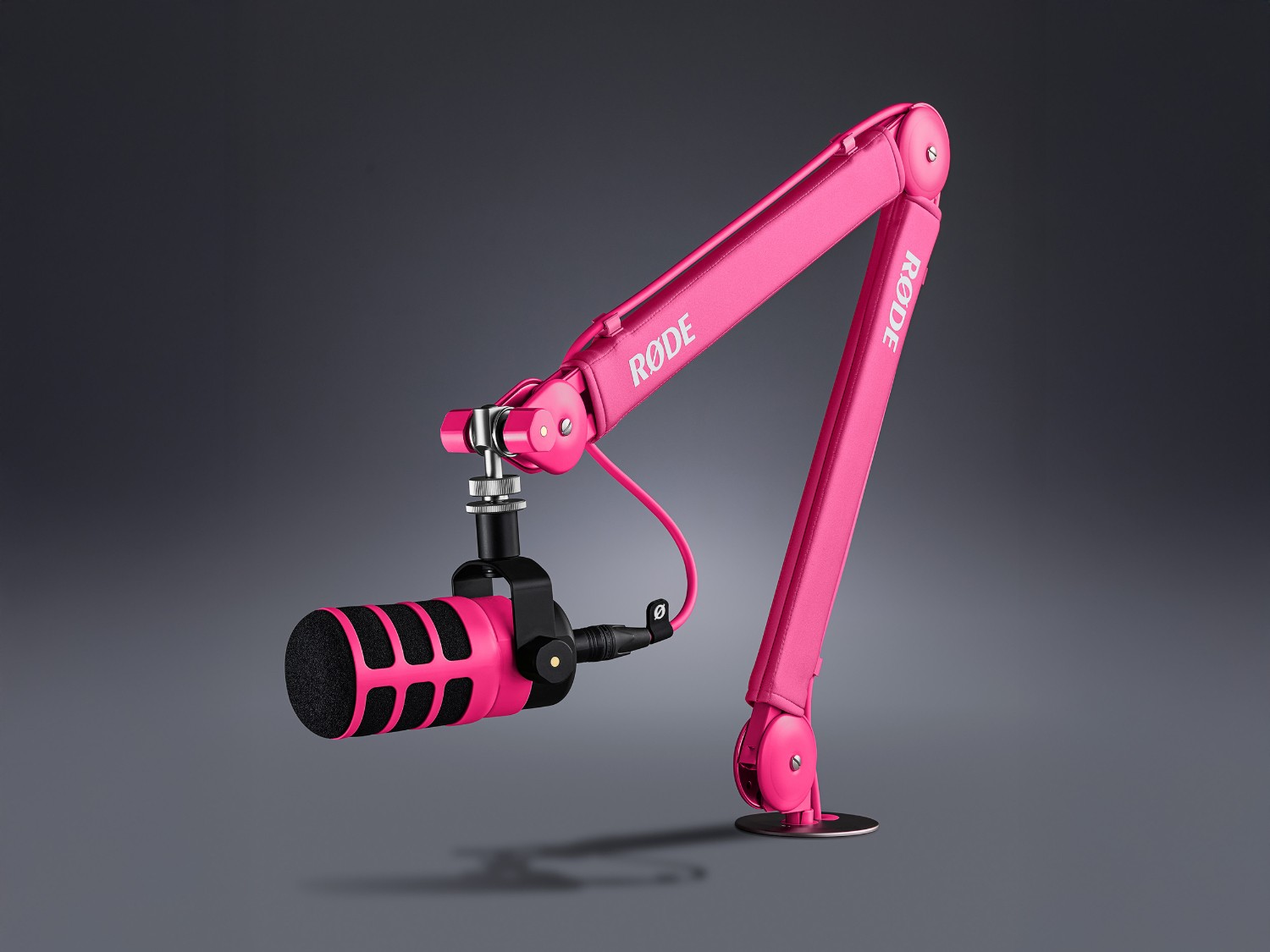 Pink RØDE PSA1+ arm with a microphone in a modern studio