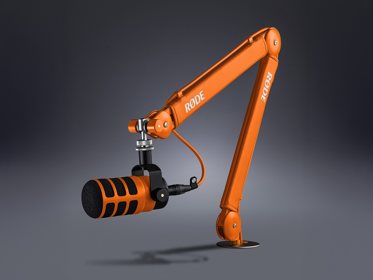 Orange RØDE PSA1+ studio arm with a microphone