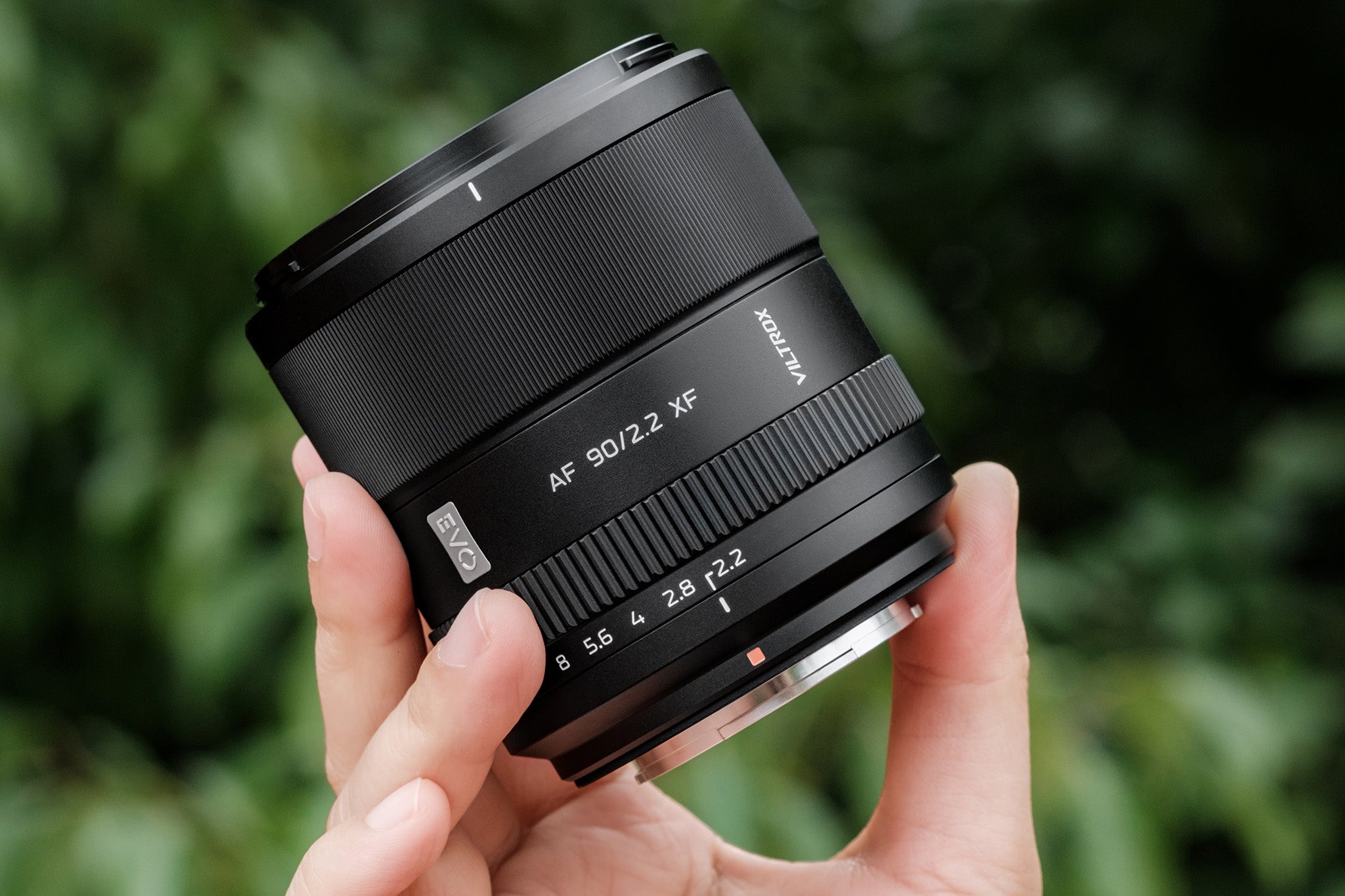 Compact Viltrox AF 90mm F2.2 XF held in hand